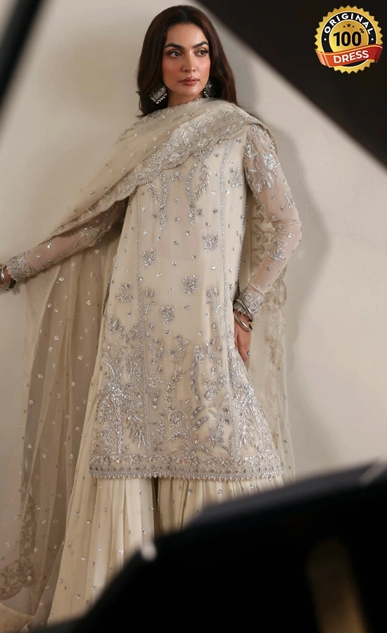 White gharara suit for wedding guests with elegant chiffon embroidery and traditional detailing