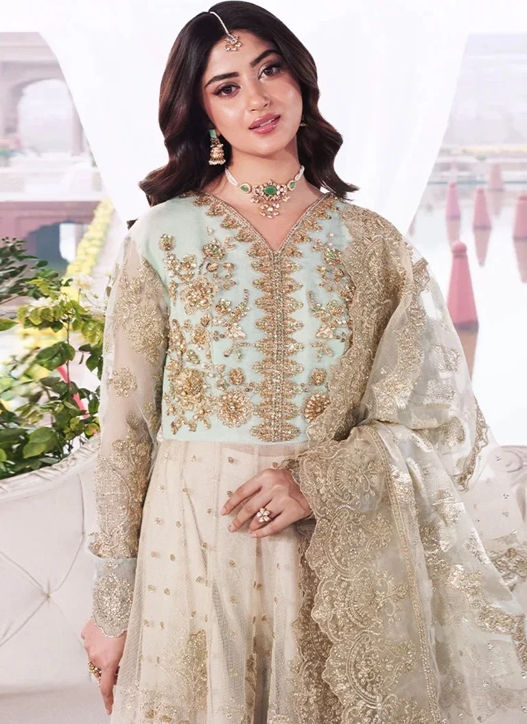 Pakistani green maxi wedding guest dress crafted in embroidered fabric with elegant traditional embellishments