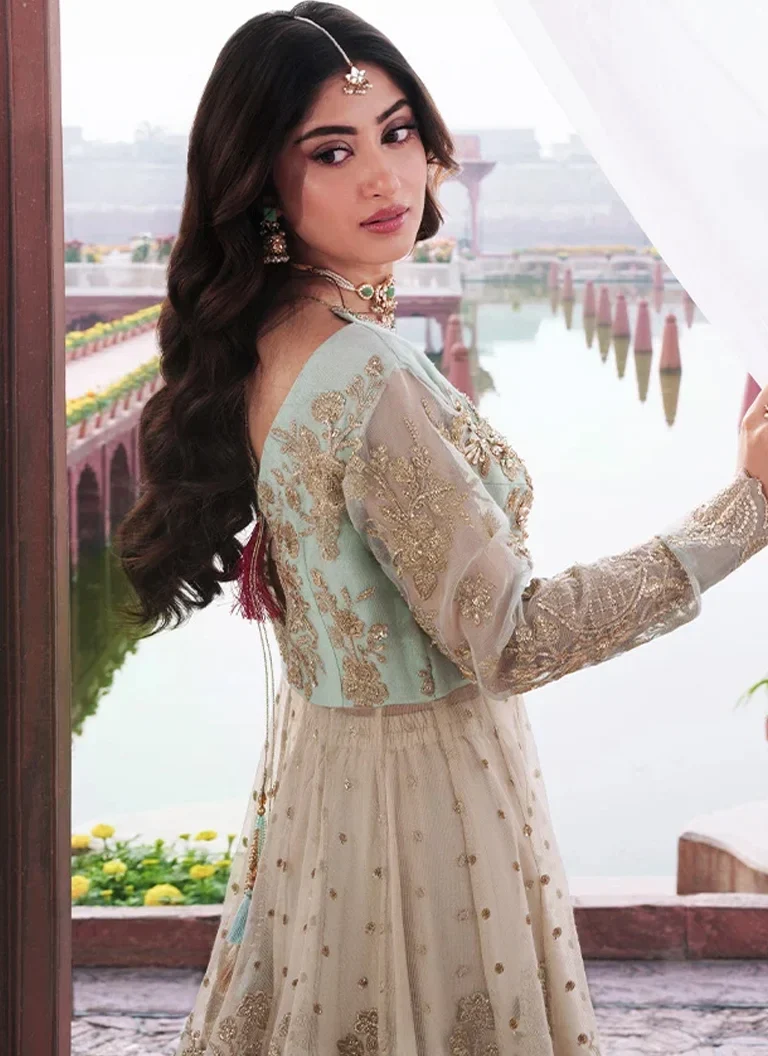 Green Pakistani wedding guest maxi dress with intricate embroidery and sophisticated formal styling
