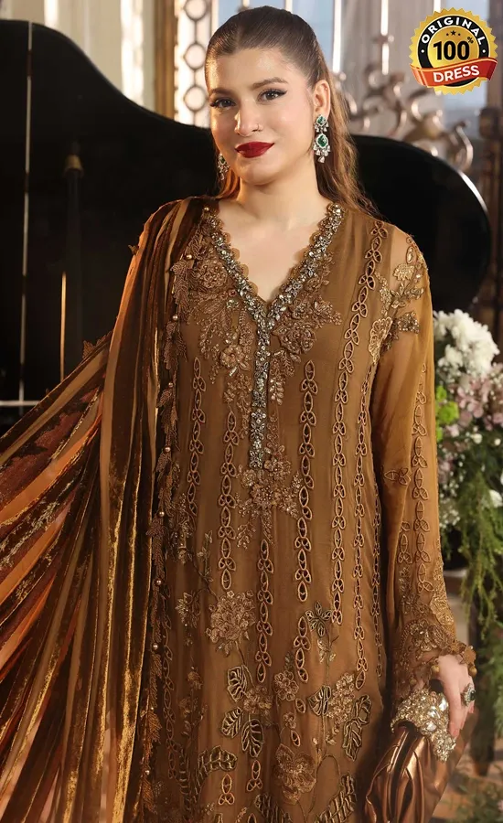 Golden Pakistani salwar kameez with intricate embroidery and luxury formal styling