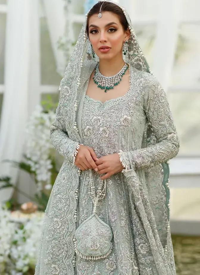 Aqua green bridal frock and lehenga with silver hand embroidery, attached cancan and long trail.