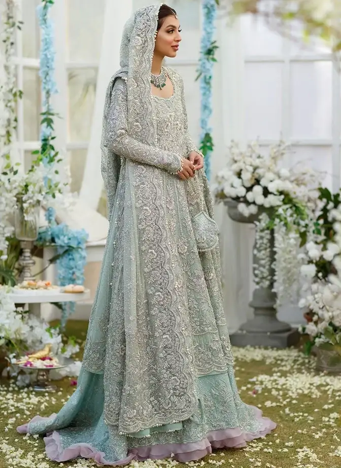 Aqua bridal outfit with ankle-length frock, tissue-silk lehenga, full sleeves and sweetheart neckline.