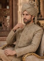 Close-up of beige silk Jamawar sherwani with tonal embroidery and matching beige turban