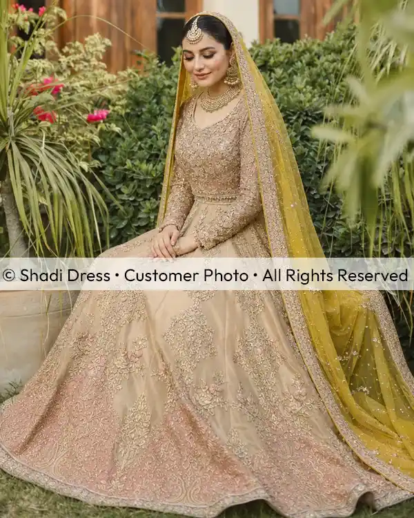 Real Shadi Dress bride wearing a champagne embroidered Pakistani bridal dress with a mustard dupatta.