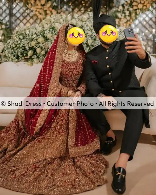 Real Shadi Dress bride wearing a maroon and gold heavily embroidered Pakistani bridal lehenga with her groom.