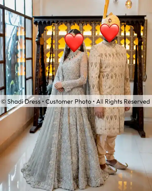 Real Shadi Dress bride wearing a silver grey embroidered Pakistani bridal gown with her groom at their wedding event.