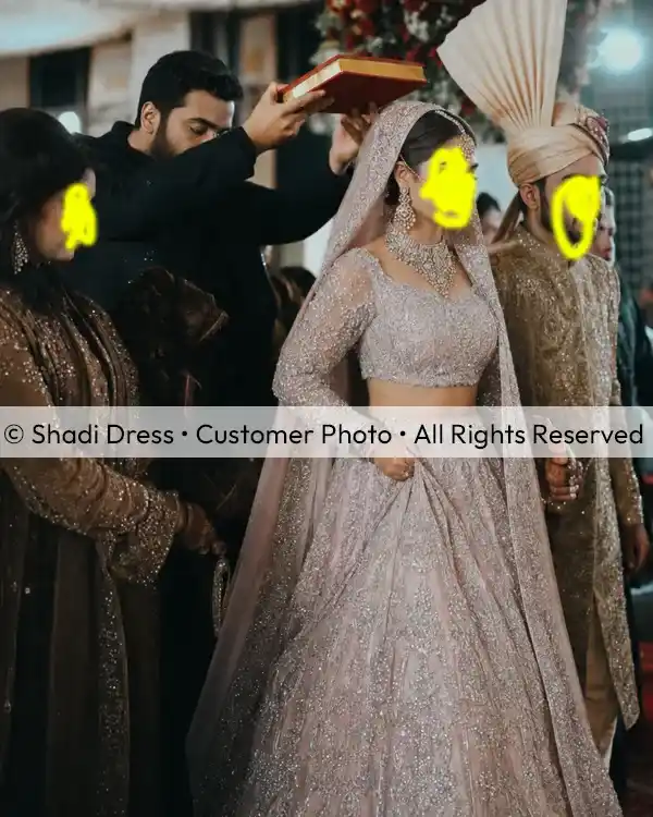 Real Shadi Dress bride wearing a silver embroidered Pakistani bridal lehenga with matching dupatta during her wedding ceremony.