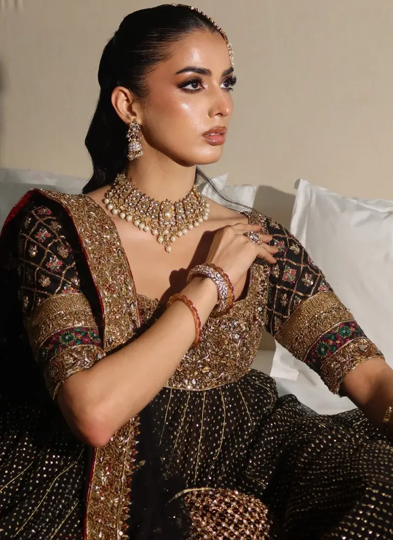 Black and gold bridal Pishwas with broad square neckline, defined waist and a wide floral embroidered hem