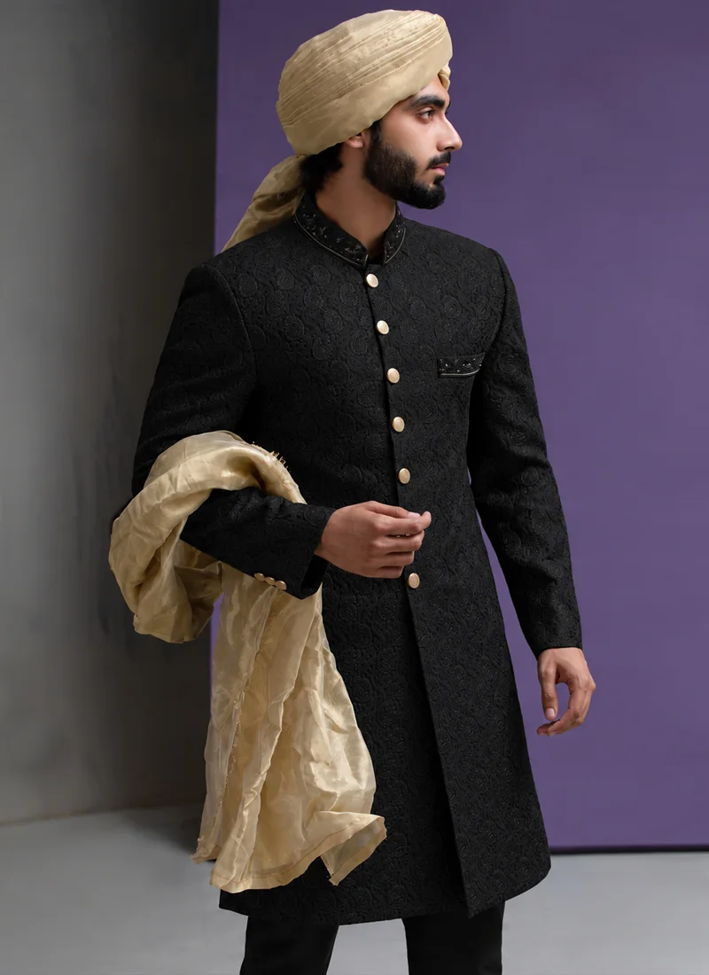 Black sherwani with gold shawl and matching turban for groom wedding wear