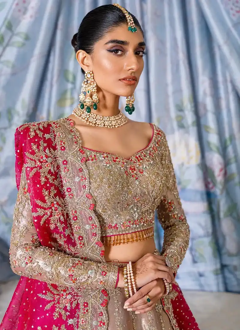 Beige baraat lehenga choli full front view with ornate gold floral hem and contrasting fuchsia dupatta
