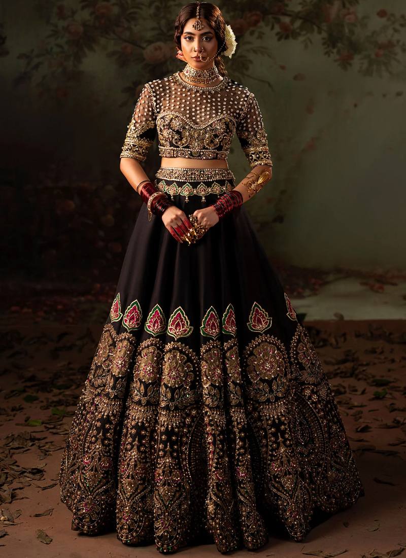 Black Baraat Lehenga Choli with Pink-Green Paisley Appliqué Black lehenga choli side close-up with pearl-dotted illusion yoke and gold-edged floral dupatta