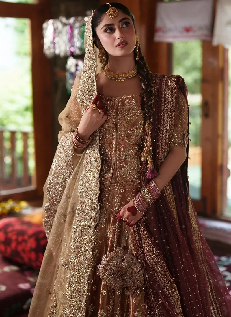 Front view of the square-neck blouse with mirrored curling gold motifs beside a narrow central trim, half sleeves and the wine dupatta over one shoulder
