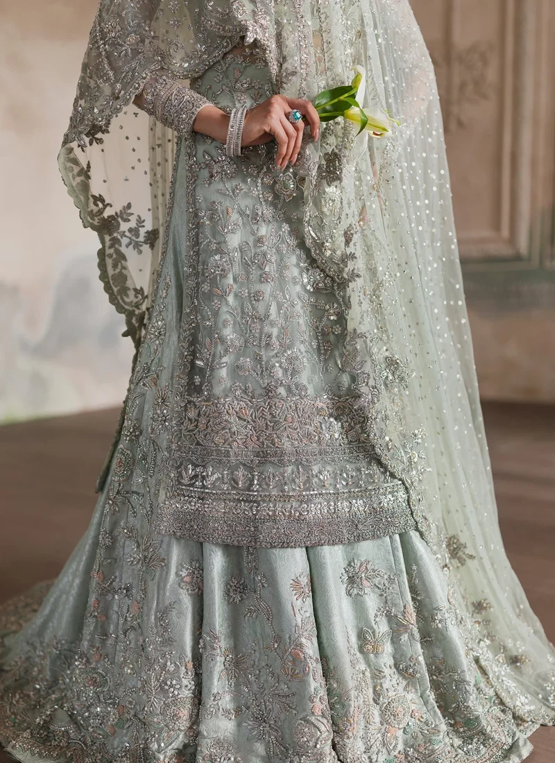 Ice blue bridal long shirt and lehenga side view with floral brocade skirt and trailing sheer net dupatta