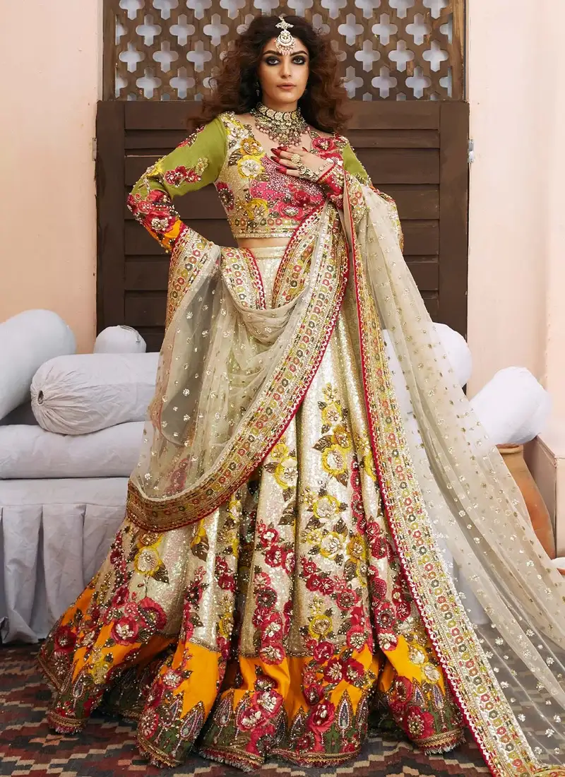 Ivory Baraat Lehenga Choli with Orange Teardrop Hem Ivory baraat lehenga choli standing front view with olive sleeves, floral embroidery and orange hem