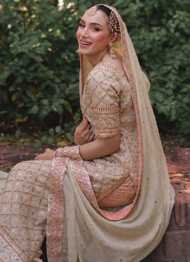 Ivory sage three-piece suit front portrait with embellished keyhole neck and broad geometric dupatta border