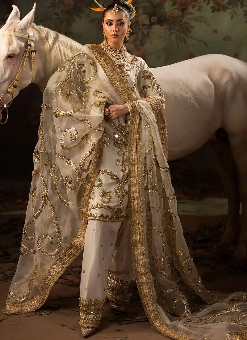 Ivory shalwar kameez full front view with gold embroidered kurti, decorated shalwar cuffs and sheer dupatta