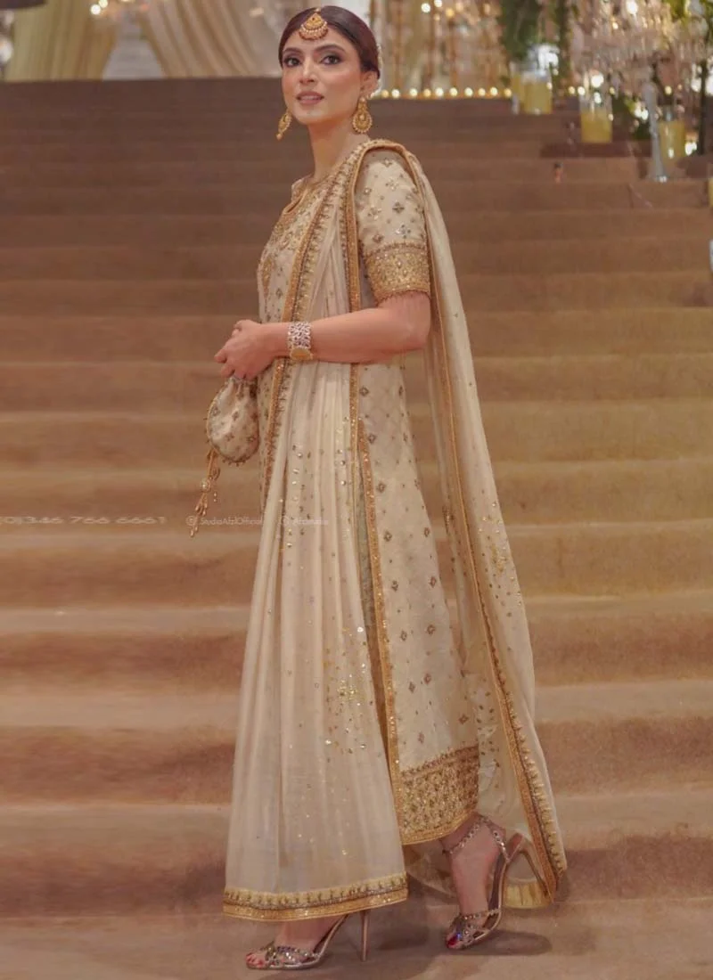Ivory gold bridesmaid long shirt suit, three-quarter view showing sheer dupatta folds and ornate gold edging