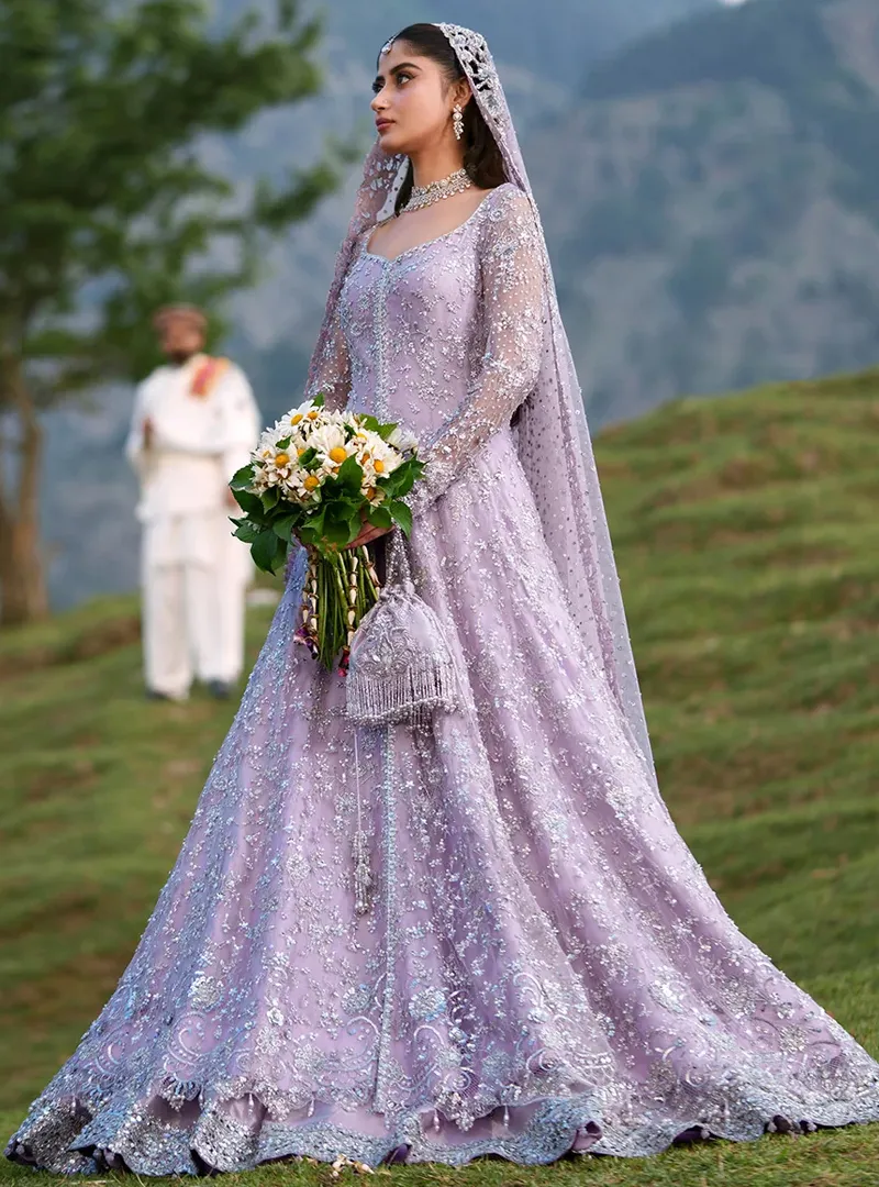 Side front view of lavender open gown with lehenga showing full flare and scalloped silver border