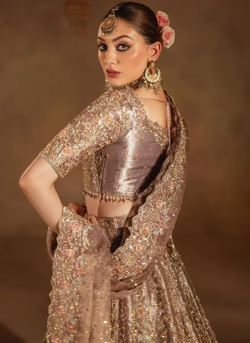 Lilac reception lehenga choli front view with a flared embroidered skirt and sheer gold-bordered dupatta