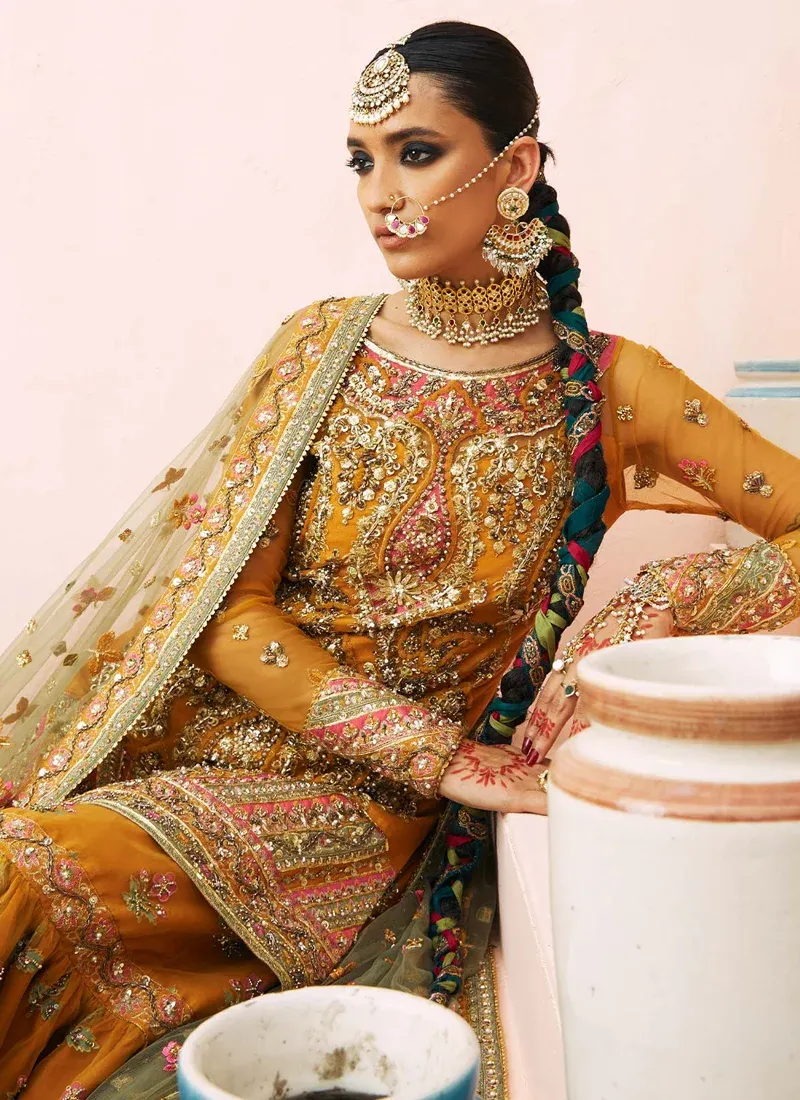 Mustard gharara suit seated detail with pink floral sprigs, embroidered cuffs and sheer olive dupatta