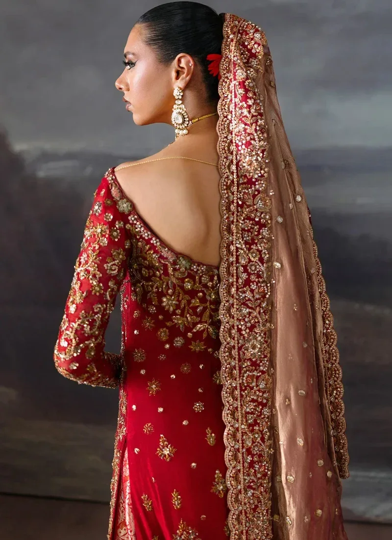 Red bridal long shirt three-quarter front view with a rose-gold dupatta and ornate scalloped borders.