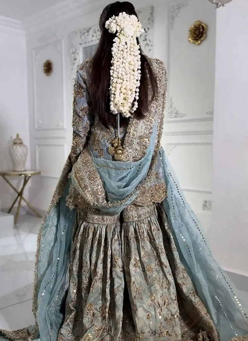 Dusty teal bridal gharara bodice close-up showing round neckline and intricate antique gold floral embroidery