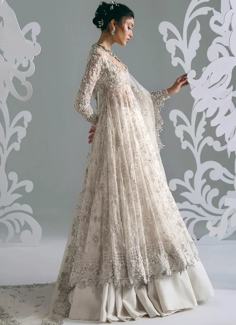 White Nikkah frock with lehenga, side view showing sheer net panels and a scalloped floral border
